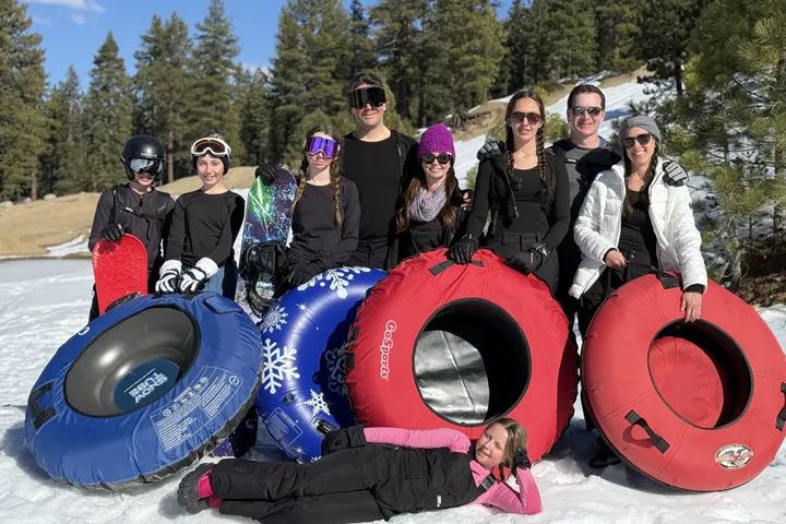 Family with snow tubes at a private sledding spot near Lake Tahoe