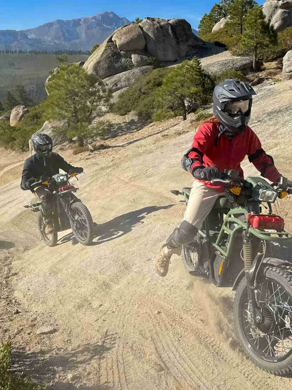 Riders on an electric dirt bike tour on a rocky trail above South Lake Tahoe