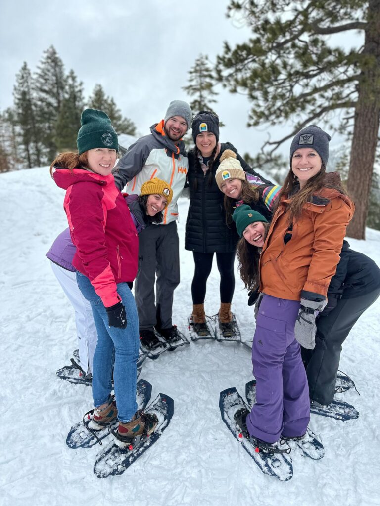 Group of women smiling together on a snowshoe tour in Tahoe